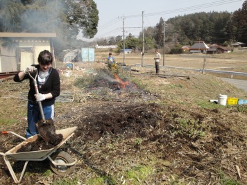 Bekah and her poo shovelling, burning in the background